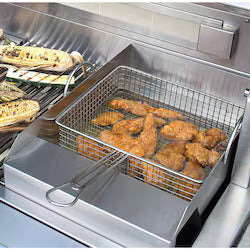 Fried chicken in a deep fryer basket on a stainless steel grill