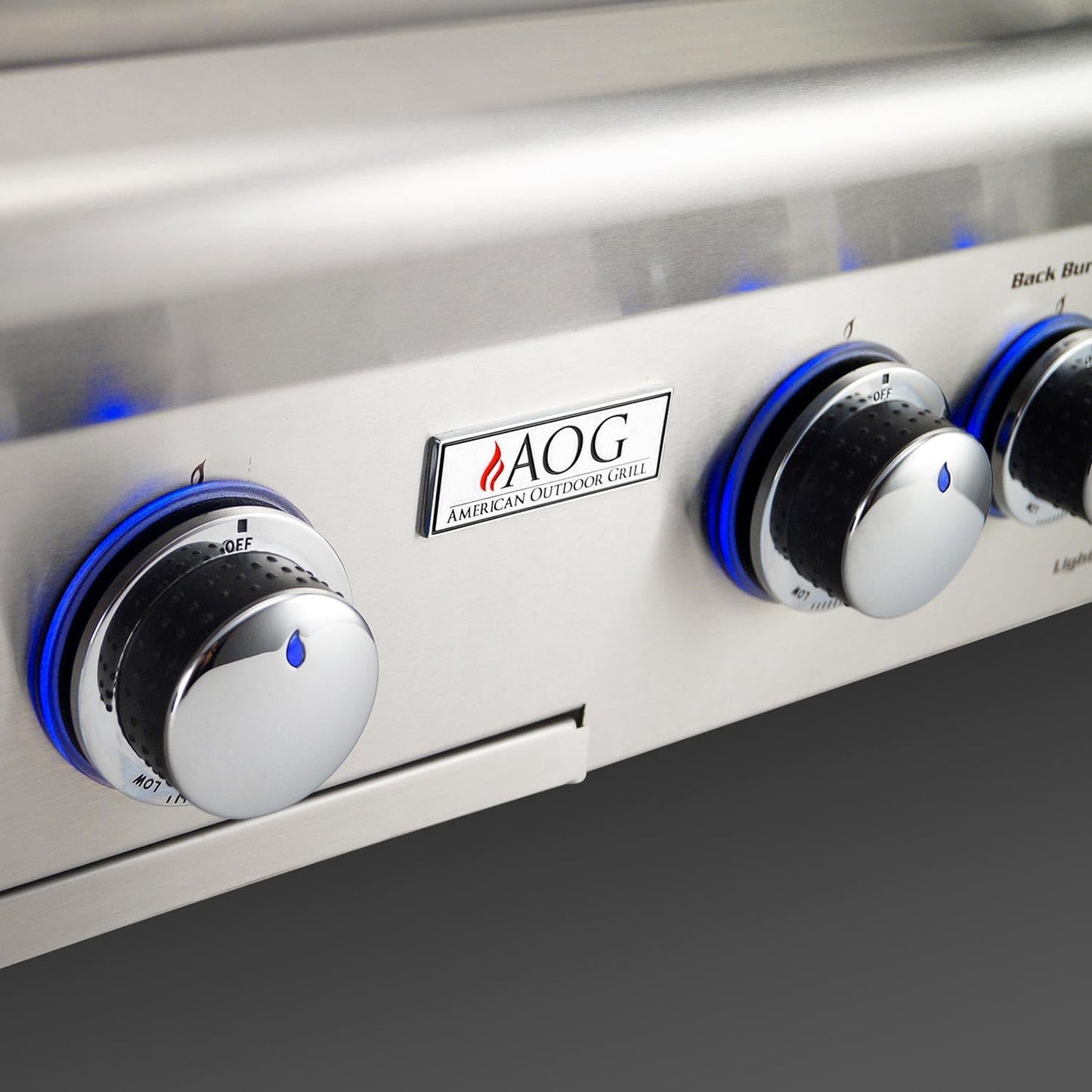 Control knobs on a grill with AOG logo