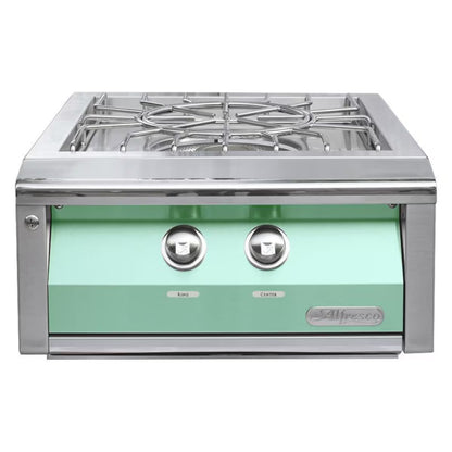 Stainless steel gas cooktop with green glass panel on a white background