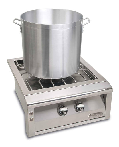 Alfresco Versa Power with a stainless steel front with a stock pot on the burner on a white background