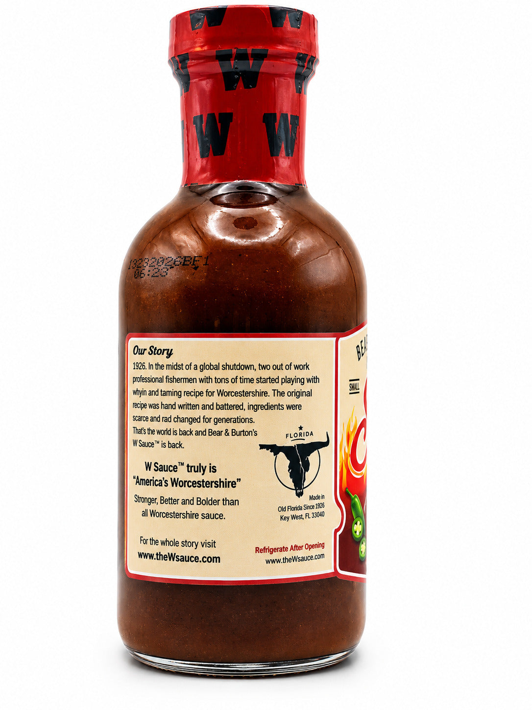 Bottle of W sauce with a red cap on a white background