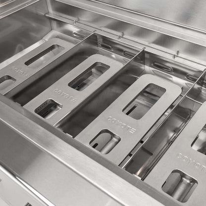 Stainless steel burners with 'Coyote' branding on a grill.