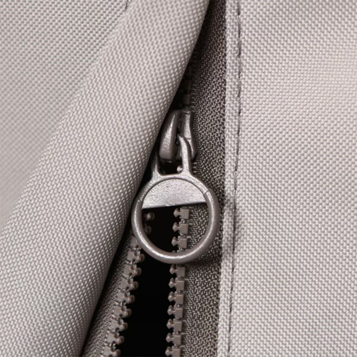 Close-up of a zipper on a gray fabric background
