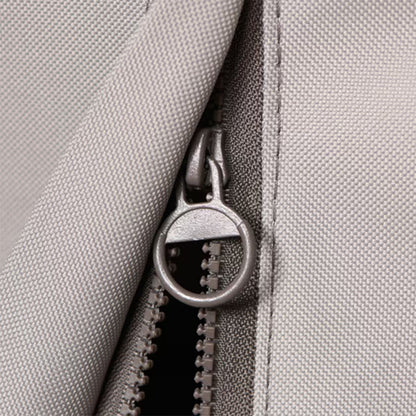 Close-up of a zipper on a gray fabric background