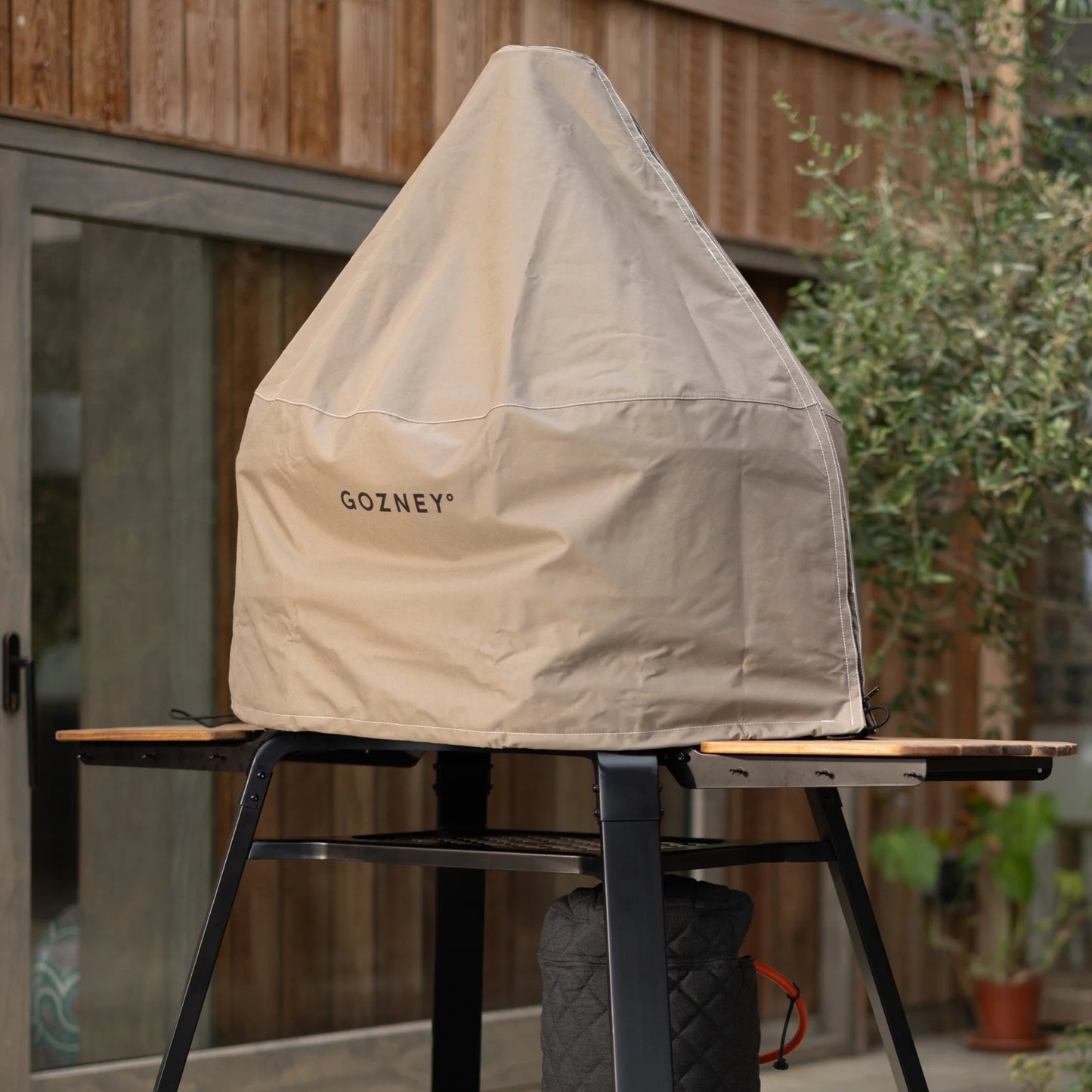Gozney Dome Xl Cover on display in a backyard 