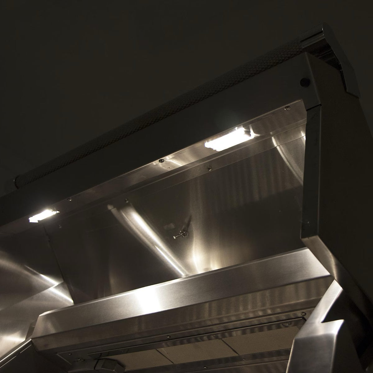 Hestan 36" Built In Gas Grill with lights on at nighttime 