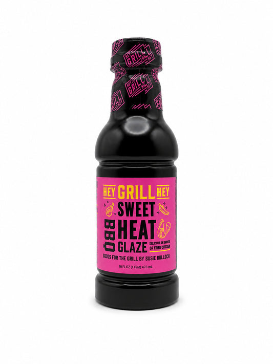 Black bottle of 'Hey Grill, Hey! Sweet Heat BBQ Glaze' with pink label on a white background