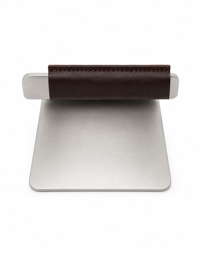 The back of a Made In Grill Press with a brown leather sleeve on a white background