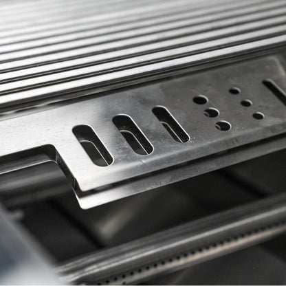 Close-up of a Mont Alpi metallic grill grate on a dark background