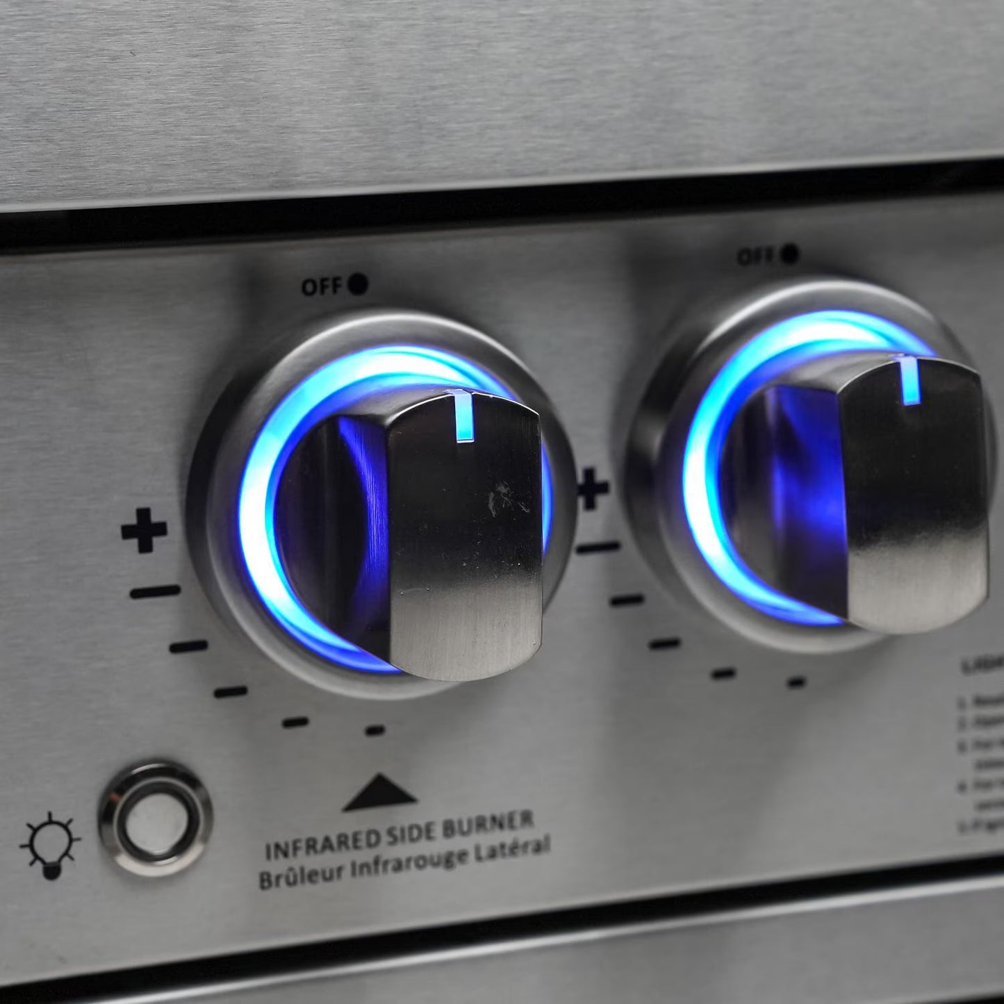 Mont AlpinClose-up of a stainless steel stove with two control knobs glowing blue.