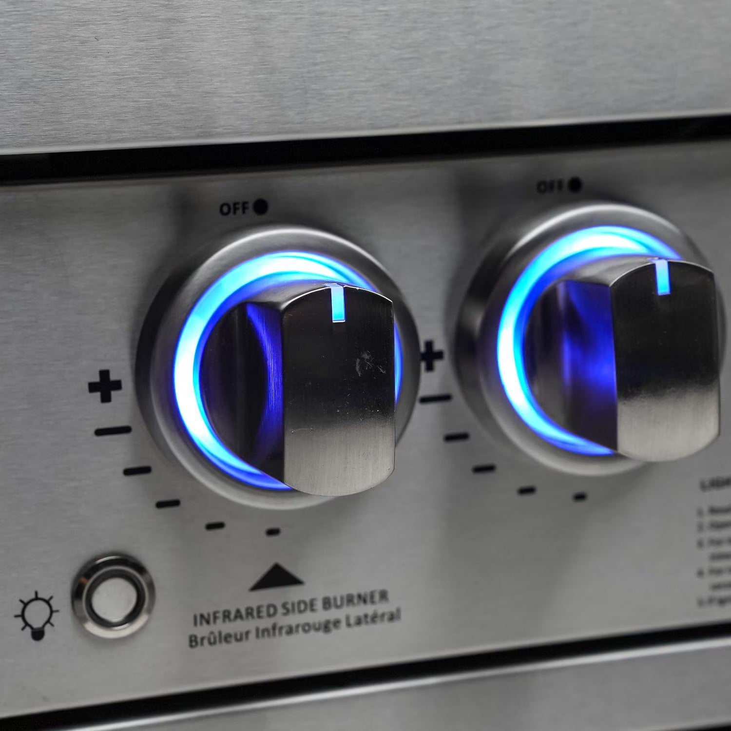 Mont AlpinClose-up of a stainless steel stove with two control knobs glowing blue.