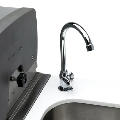 Mont Alpi Chrome kitchen faucet on a white countertop with a neutral background
