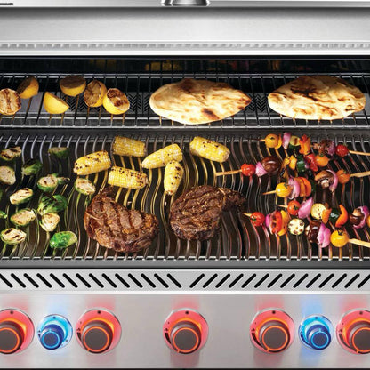 Napoleon Prestige 665 5-Burner Grill with Rotisserie & Side Burner with food grilling on it with illuminated knobs