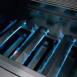 Close-up of gas stove burners with blue flames