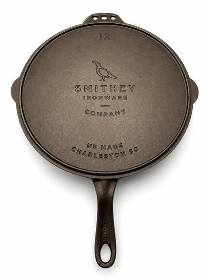 Smithey Ironware 12" Cast iron flat top Griddle bottom with 'Smithey Ironware Company' branding on a white background