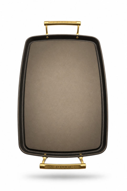 Smithey Ironware Double Burner Griddle with gold handles on a white background