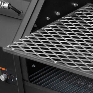 Close-up of a grill with a metal grid on a black background